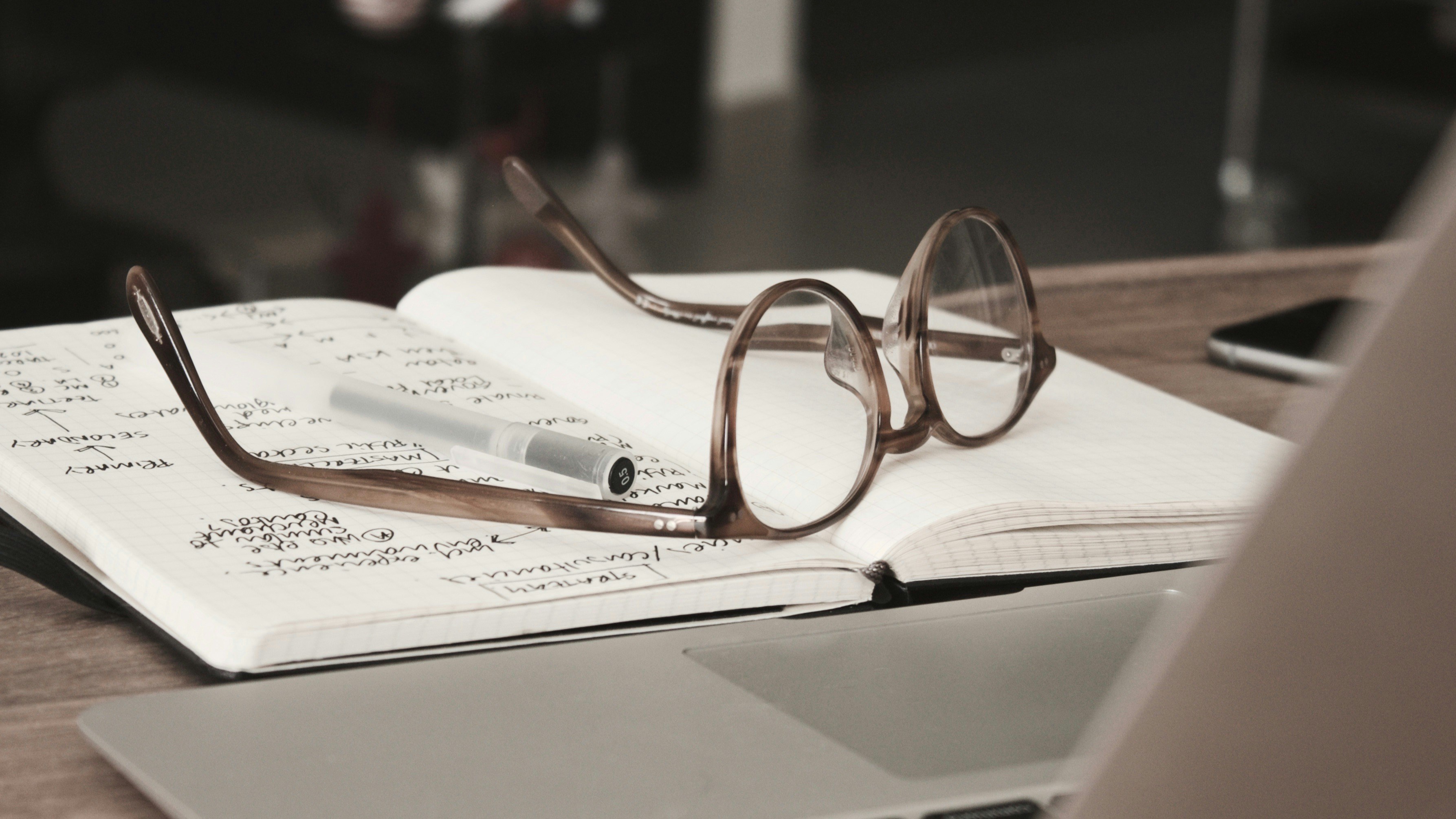 Desk with glasses and notebook